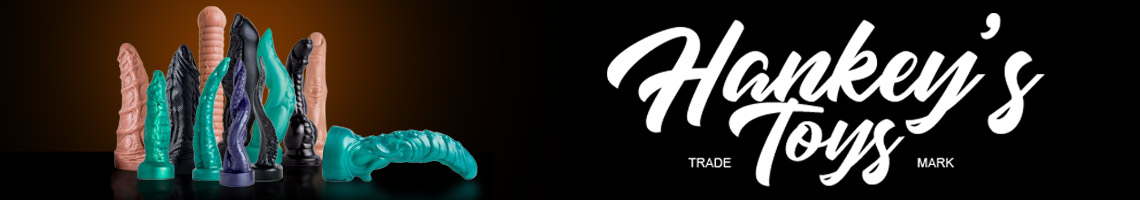 This image displays a varied selection of Hankey's Toys in various textures. Featuring fantasy dildos in alien-like shapes, animal shapes, in tanned flesh, metallic green, metallic purple, and black.